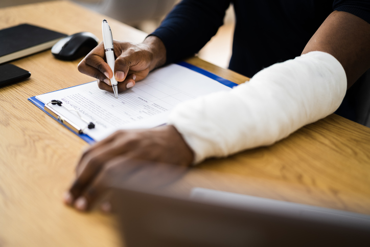 Personal injury claim signing paperwork to receive a settlement
